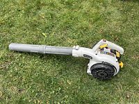 Side view of Ryobi gas powered leaf blower showing the blower tube, handle, and engine housing.