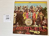 Front cover of The Beatles Sgt. Pepper's Lonely Hearts Club Band 1st Canadian vinyl LP with catalog MAS2653, featuring detailed group photo and colorful design.
