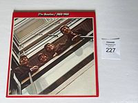 Front cover of The Beatles 1962-1966 vinyl LP with band members leaning over a stairwell.