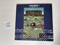 Front cover of The Who Hooligans LP album with band name and flooded yard artwork.