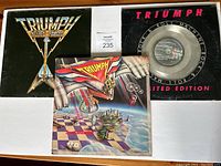Front covers and vinyl of three Triumph albums showing label and condition.