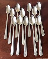 All 12 spoons displayed on tabletop, full view