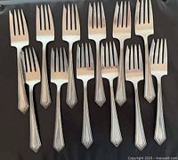 All twelve Alvin Richmond sterling forks laid out