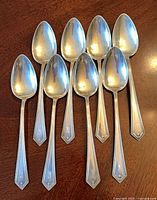 All eight Alvin Richmond serving spoons arranged on tabletop