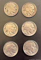 Six Buffalo Nickel obverses displayed, showing dates and wear
