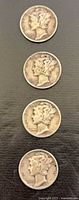 Four 1940 Mercury dimes obverse view