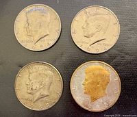 Four Kennedy half dollars obverse view
