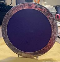 Front view of round sterling frame with purple insert