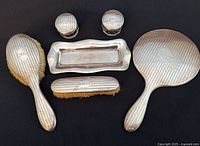 Full view of six sterling silver vanity pieces