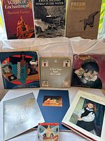 Group shot of all ten art books showing covers