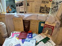 Overall lot showing variety of choral scores on table and propped up