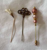 All three stick pins side by side showing overall designs