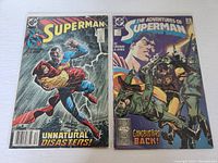 Photo showing two Superman comic books from the 1980s, Superman #38 (1989) and The Adventures of Superman #446 (1988) with their front covers visible on a white background.