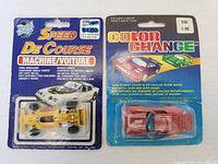 Front view of both sealed toy cars side by side, showing package details.