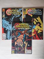 Three Armed & Dangerous comic books laid flat, showing front covers of issues #1, #3, and Special. Covers exhibit vibrant comic art, minor wear visible.