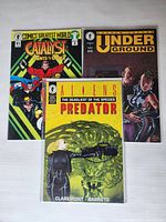 Photo showing three vintage Dark Horse comics: Aliens Vs Predator The Deadliest of the Species #4, Catalyst Agents of Change #4, and Underground #2.