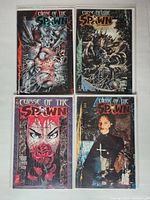 Top-down photo of four Curse of the Spawn comic books arranged in a 2x2 grid on a white surface. Covers visible showing each issue number and title.