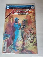 Front cover of Action Comics #988 showing Superman with a female character, lenticular effect visible.