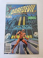 Cover of Daredevil #208 comic book showing Daredevil in red costume standing on stairs with building and gargoyles in background.