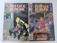 Photo of Justice League America comics #49 and #78 showing front covers with characters and titles visible.