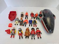 Full lot with spaceship and multiple Playmobil figures spread out on white surface