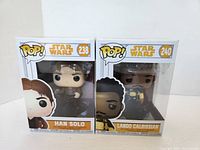 Front view photo showing unopened Han Solo and Lando Calrissian Star Wars Pop! Funko figures in box packaging, numbered 238 and 240 respectively.