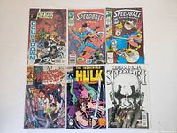 Photo of six Marvel comic books including The Avengers, Speedball (2), Amazing Spider-Man, The Incredible Hulk, and Doctor Strange