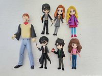 Photo of the 7 Harry Potter figures posed on a white background