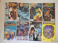 Photo showing all 8 independent comic books laid out in two rows with visible covers.