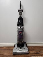 Front full view of Bissell Aero Swift Compact upright vacuum showing handle, dust container, and base with suction control dial.