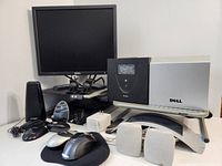 Front view showing Dell LCD monitor on stand, two computer mice on mousepad, monitor stands, and speakers.