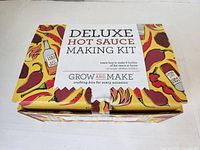 Box top showing the product name and branding with colorful chili-themed graphics.