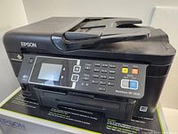 Front angle view of Epson Workforce WF-3620 printer showing control panel and general condition.