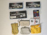 Photo shows vintage coin purses including yellow, tan, white, and beige purses alongside coin collecting sleeves and holders.