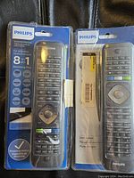 Two Philips brand 8 in 1 streaming universal remotes in sealed plastic packaging