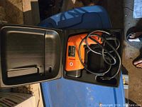 Orange Black & Decker Heat 'n Strip paint remover inside its molded plastic carrying case in open position.