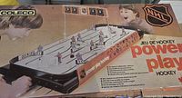 Box of vintage Coleco Power Play Hockey tabletop game with NHL logos and child players depicted, showing the game set-up and branding.