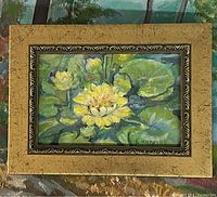 Framed floral painting showing yellow flowers and green lily pads, signed by Lydia Knox Hill.