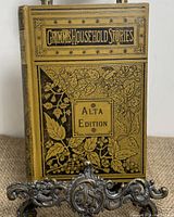 Front cover with ornate black floral design and title 'Grimm's Household Stories Alta Edition'