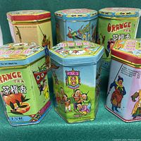 Front view of all 6 vintage Chinese hexagonal tea tins grouped showing colorful detailed designs and lids.