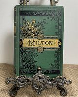 Front view of antique green hardcover book titled 'Milton' with gold and black decorative accents.