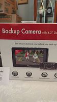 Box front showing image of 4.3 inch color LCD dash monitor displaying live feed and backup camera image, highlighting size and usage.