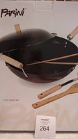 Box showing Parini branding and contents including wok, lid, chopsticks, spatulas.