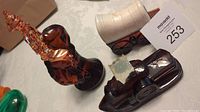 View of all three vintage Avon cologne bottles: bucking bronco horse, covered wagon, paddle wheeler