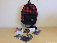 Photo showing Roots knapsack, umbrella, gloves, flashlight, knife, stencil all together