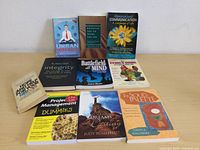 Photo showing 10 different books arranged on a flat surface.
