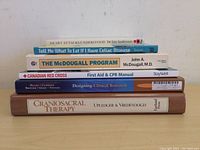 Photo showing stacked spines of the six health-related books to identify titles and authors.