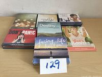 Seven sealed Joyce Meyer DVDs laid out on wooden table showing titles and cover art.