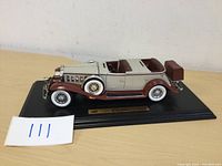 Side angle view of 1932 Cadillac Sport Phaeton model car showcasing the brown and beige colors and detailed wheels.