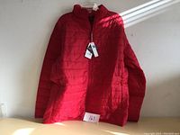 Front view of the men's large red ski jacket, showing full length zipper and quilting pattern.